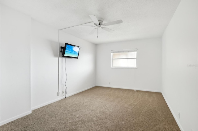 spare room featuring carpet flooring and ceiling fan