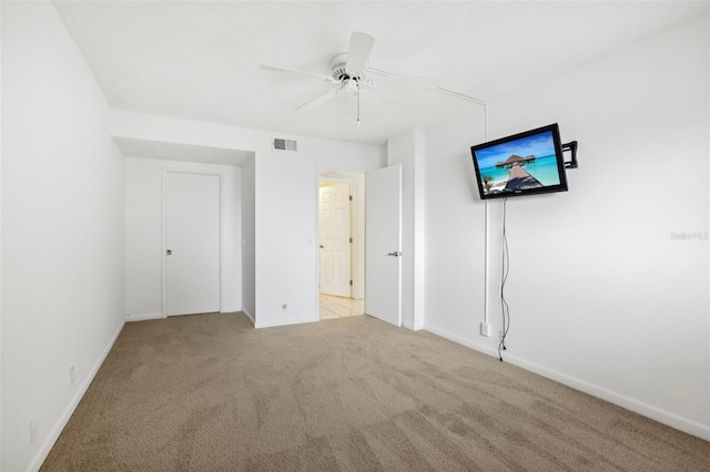 unfurnished bedroom with light carpet and ceiling fan