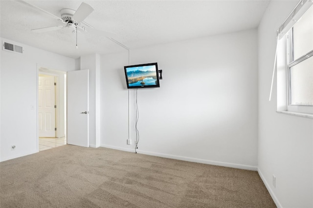 spare room with light carpet and ceiling fan