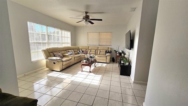 tiled living room featuring ceiling fan and a textured ceiling