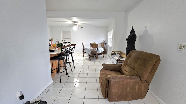 tiled living room with ceiling fan