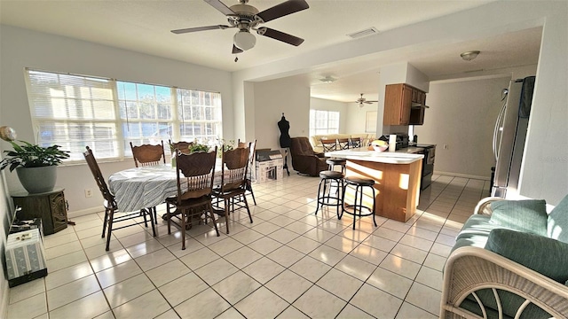 tiled dining area featuring ceiling fan