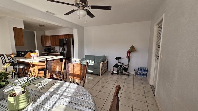 dining area with ceiling fan and light tile patterned flooring