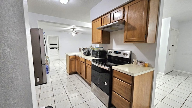 kitchen with kitchen peninsula, appliances with stainless steel finishes, light tile patterned floors, and ceiling fan