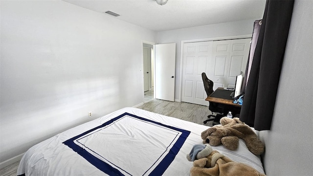 bedroom featuring a closet and light wood-type flooring