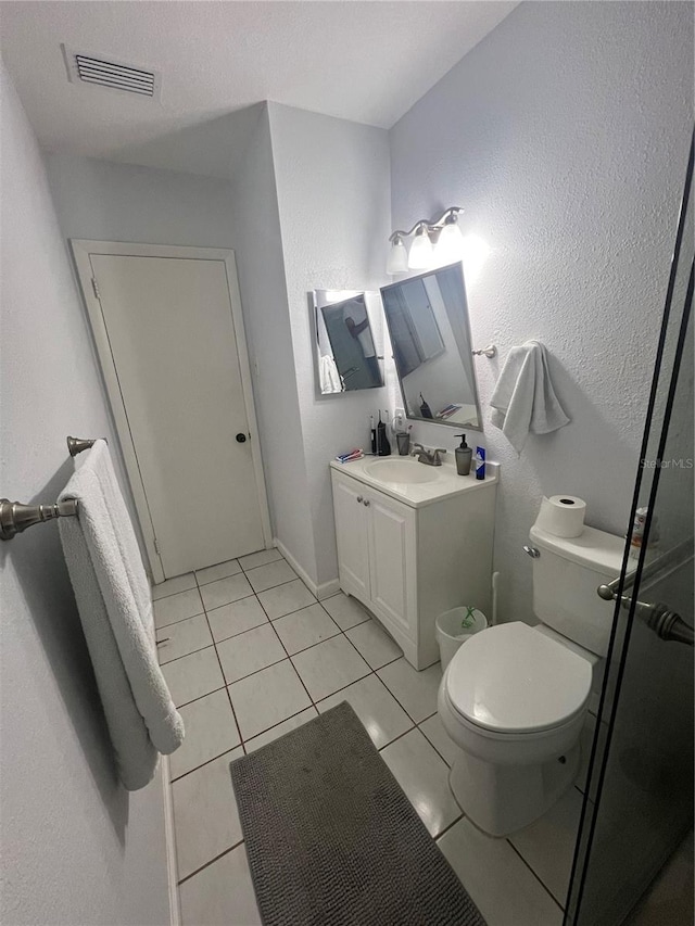 bathroom with tile patterned floors, vanity, and toilet