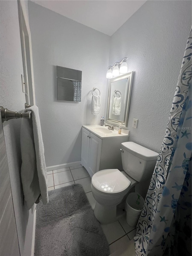 bathroom featuring tile patterned floors, vanity, and toilet