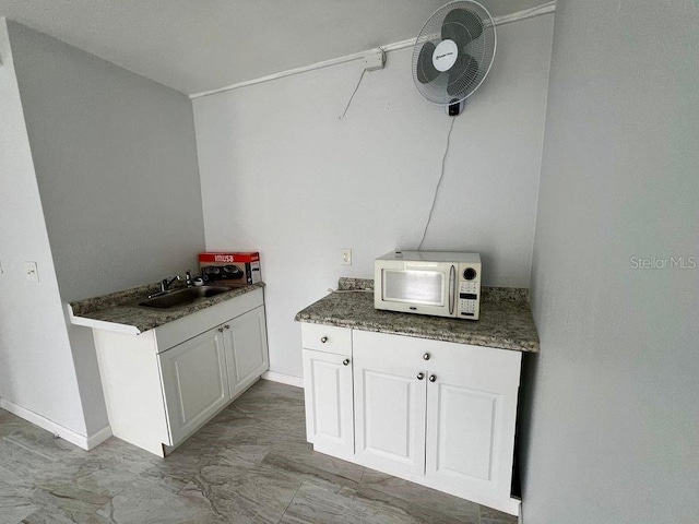 kitchen with white cabinets and sink