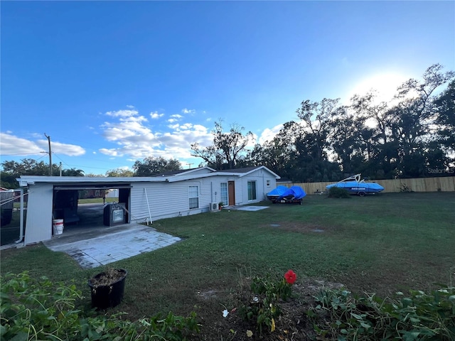 exterior space featuring a lawn and a carport