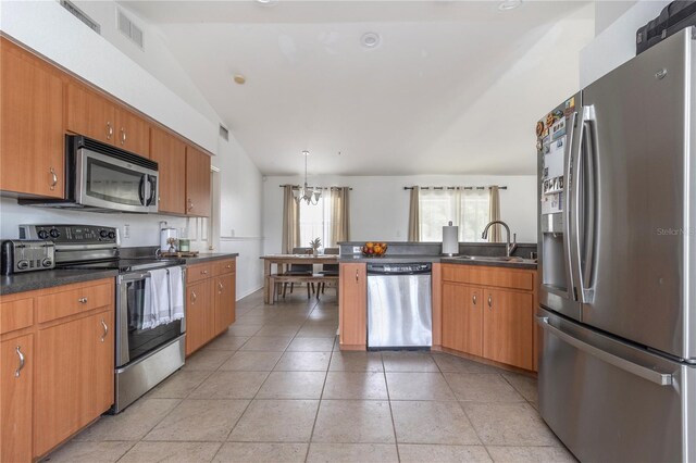 kitchen with appliances with stainless steel finishes, sink, a notable chandelier, hanging light fixtures, and lofted ceiling