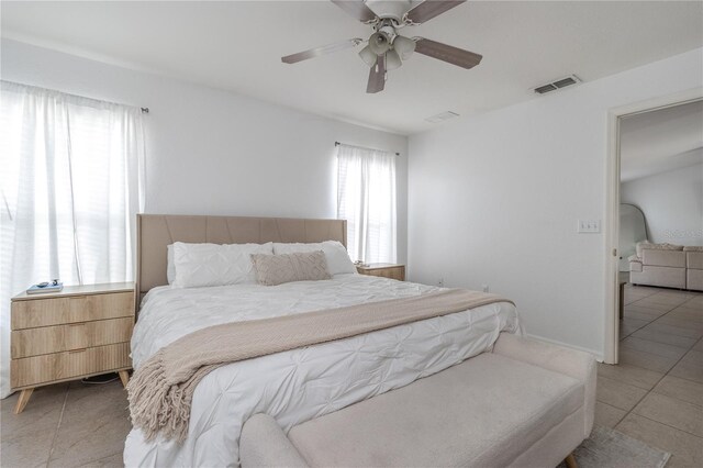 bedroom with ceiling fan and light tile patterned flooring