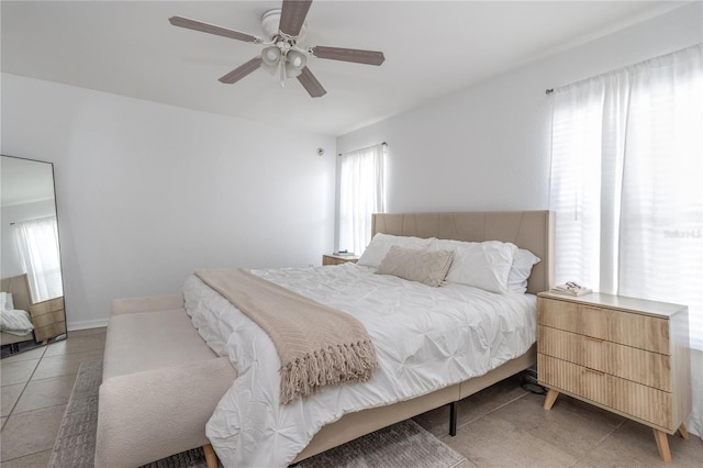 bedroom featuring tile patterned floors and ceiling fan