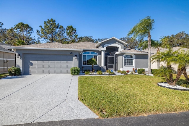 single story home featuring a garage and a front lawn