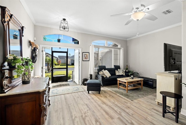 foyer entrance with ceiling fan with notable chandelier, light hardwood / wood-style floors, and ornamental molding