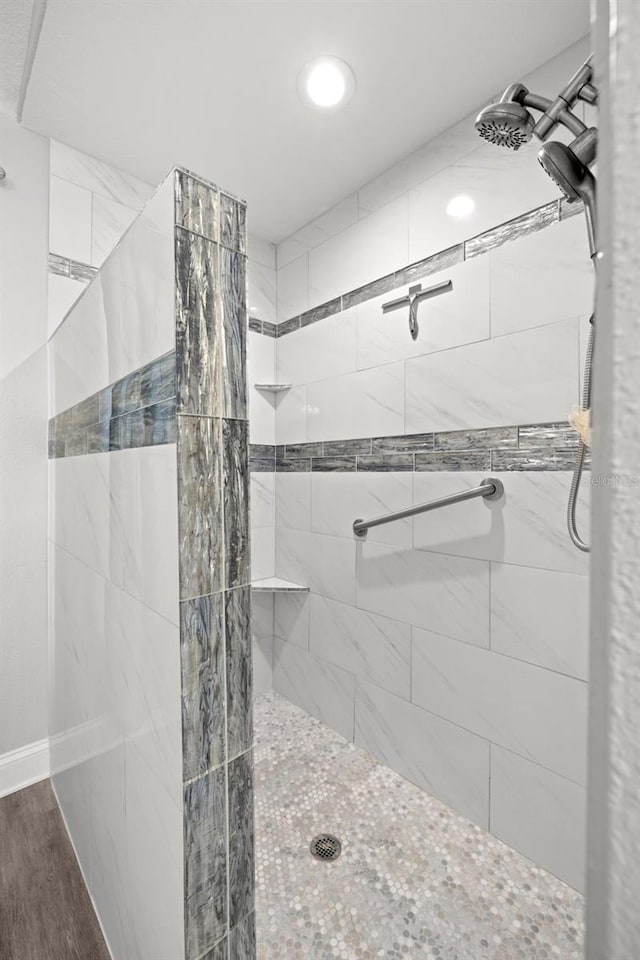 bathroom featuring tiled shower and hardwood / wood-style flooring