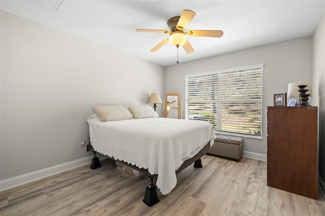 bedroom with ceiling fan and light hardwood / wood-style flooring