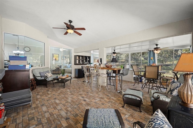 living room with vaulted ceiling and an inviting chandelier