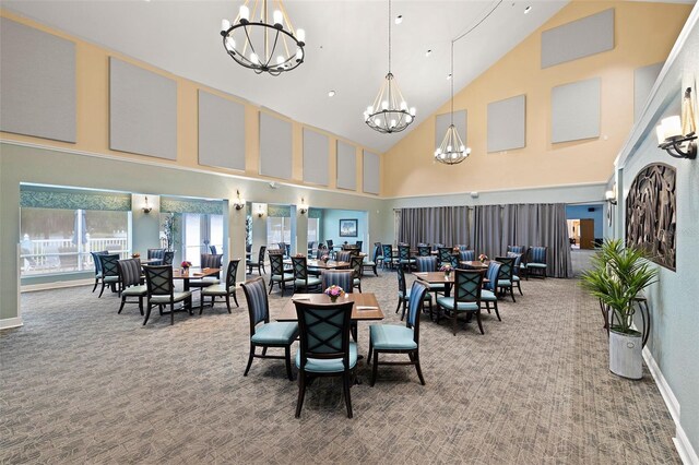 carpeted dining room featuring high vaulted ceiling