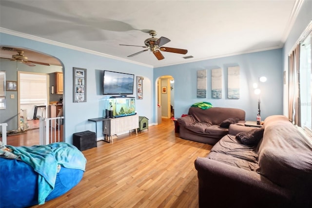 living room featuring ceiling fan, light hardwood / wood-style floors, and ornamental molding