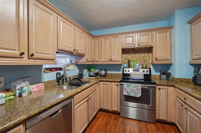 kitchen with dark wood-type flooring, stone counters, sink, a textured ceiling, and appliances with stainless steel finishes