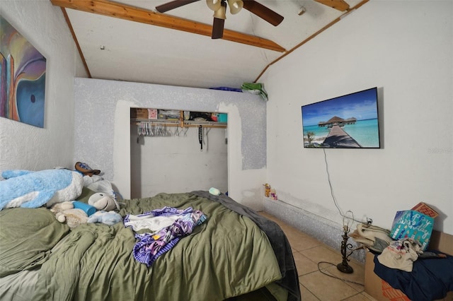 bedroom with beam ceiling, a closet, ceiling fan, and tile patterned flooring