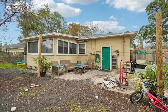 rear view of property featuring a patio and central AC unit