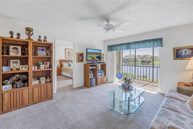 carpeted living room featuring a textured ceiling and ceiling fan