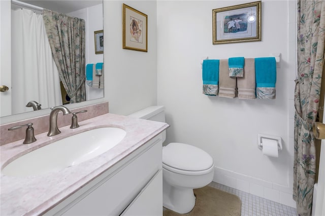 bathroom featuring tile patterned flooring, vanity, and toilet