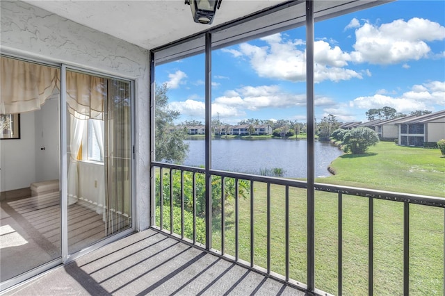 unfurnished sunroom with a water view