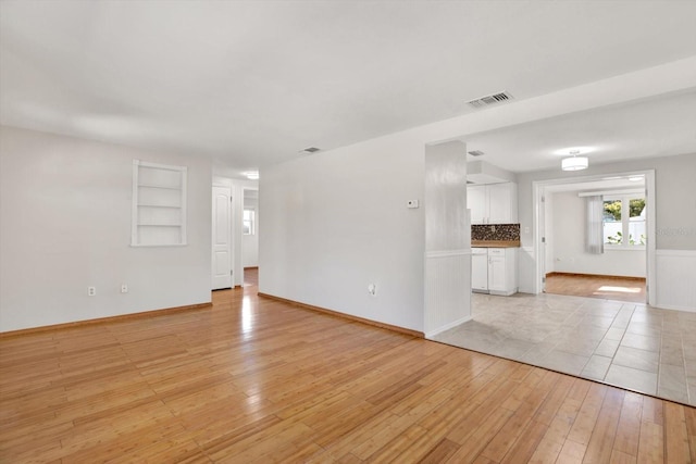 unfurnished living room with light wood-type flooring