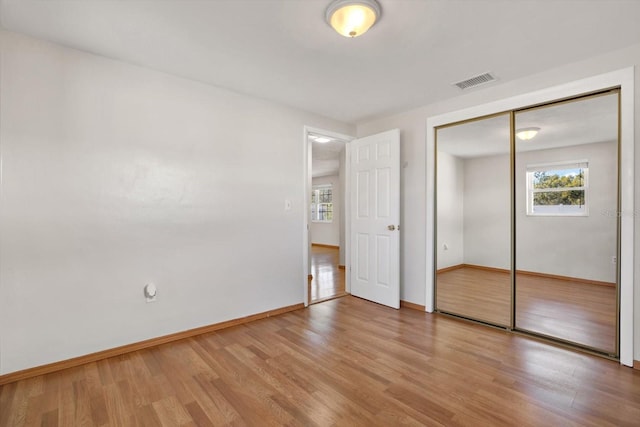 unfurnished bedroom featuring a closet and light hardwood / wood-style flooring