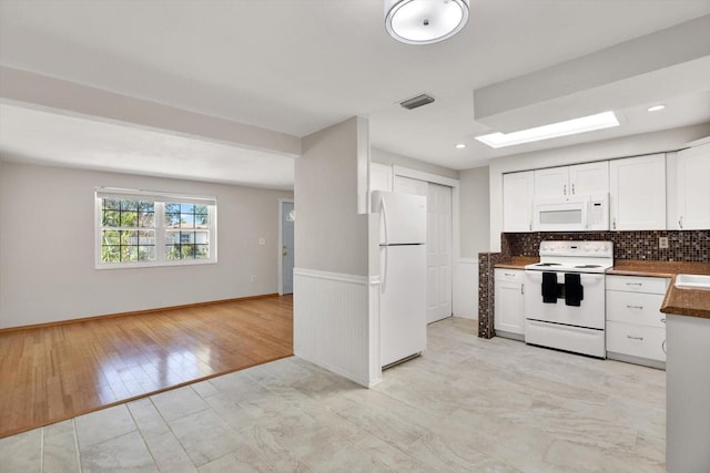 kitchen featuring tasteful backsplash, white cabinetry, white appliances, and light wood-type flooring