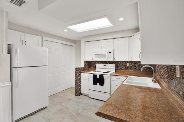 kitchen with backsplash, white cabinetry, white appliances, and sink