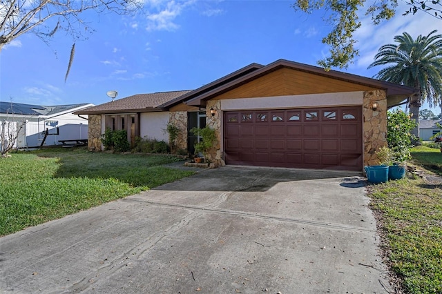 ranch-style home featuring a garage and a front lawn