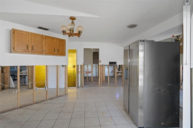 kitchen featuring a chandelier, stainless steel fridge with ice dispenser, a textured ceiling, and light tile patterned flooring