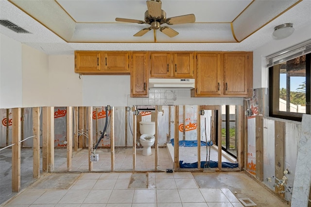 kitchen featuring ceiling fan and a textured ceiling