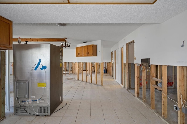 basement featuring a textured ceiling, wooden walls, and light tile patterned flooring