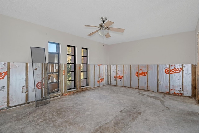 unfurnished room featuring a textured ceiling and ceiling fan