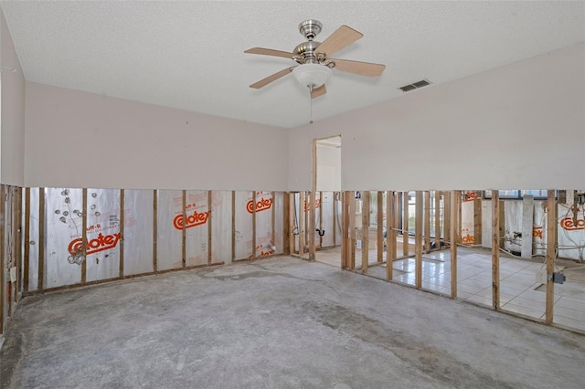 spare room featuring a textured ceiling and ceiling fan