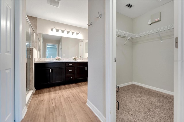 bathroom with vanity, hardwood / wood-style flooring, and an enclosed shower