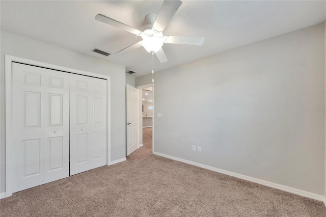 unfurnished bedroom featuring carpet flooring, ceiling fan, and a closet