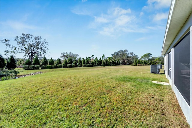 view of yard featuring central air condition unit