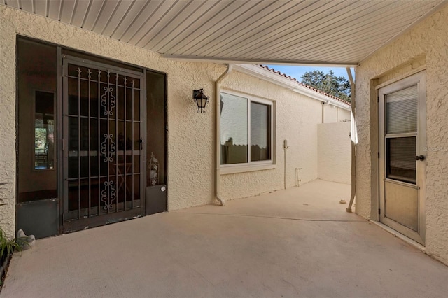 entrance to property with a patio