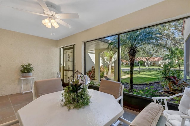 tiled dining space featuring ceiling fan