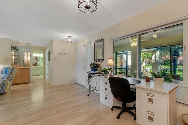 office area with a textured ceiling and light hardwood / wood-style floors