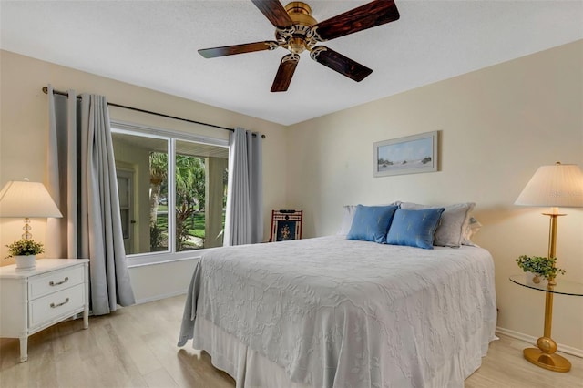 bedroom featuring light hardwood / wood-style floors and ceiling fan