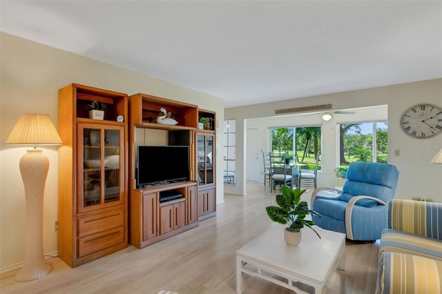 living room featuring light hardwood / wood-style floors and ceiling fan