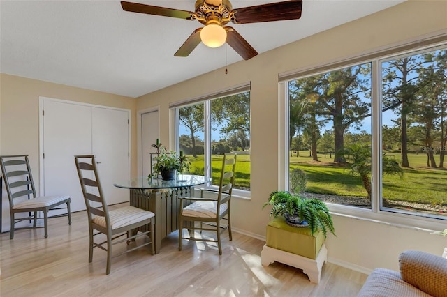 sunroom / solarium featuring ceiling fan