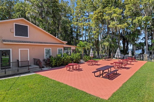 view of home's community featuring a yard and a patio