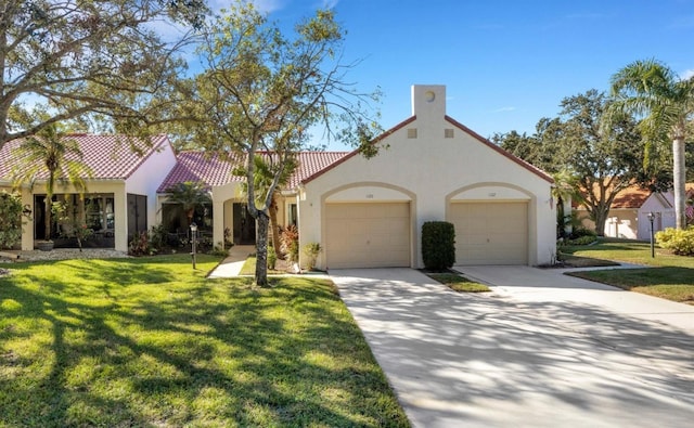 mediterranean / spanish house with a front yard and a garage